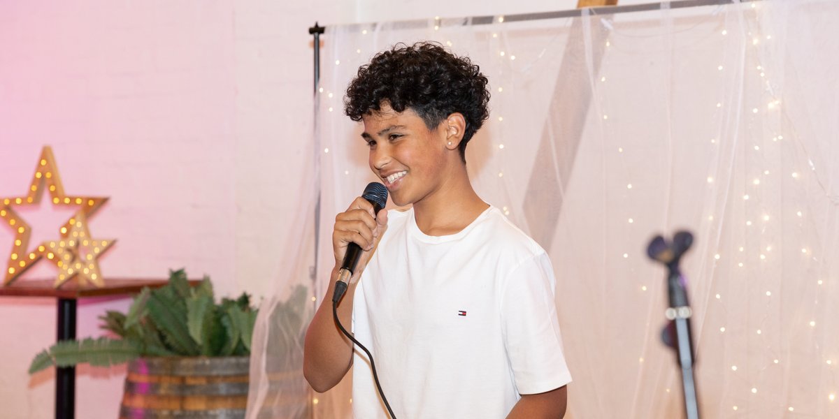 Young student singing at a Madeline Music showcase